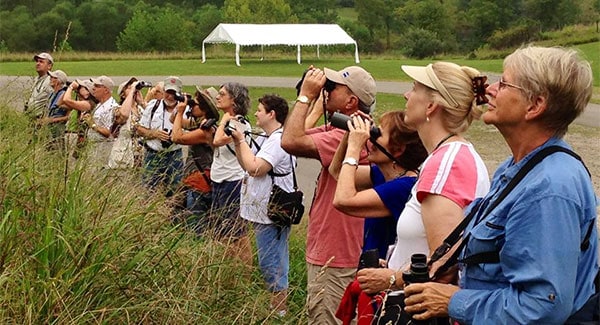Bird watchers use binoculars at a BWD Reader Rendezvous. Photo by Bill Thompson, III